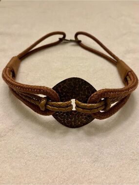 Vintage woven waist belt with hammered metal medallion